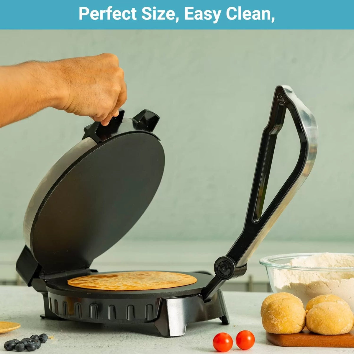Open roti maker with a cooked flatbread on its round lower plate