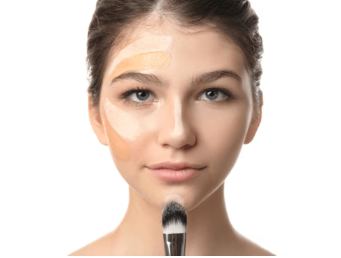 Miss Rose liquid foundation applied in patches on a model's face, with a makeup brush below