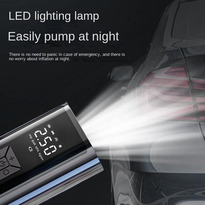 Digital air compressor with a built-in LED light illuminating a car tire.