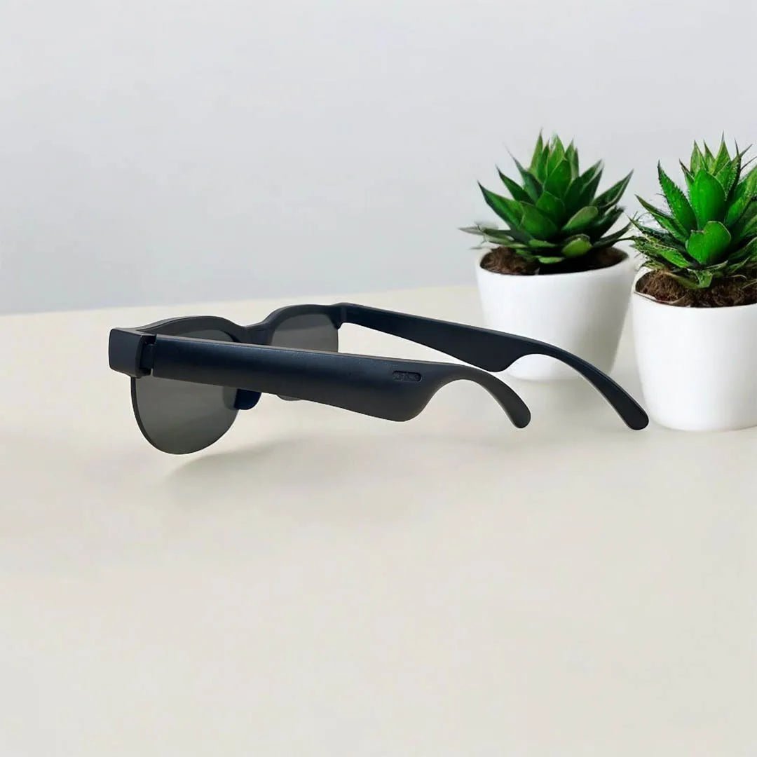 Black wireless headset glasses shown from the side, with dark lenses and thick temples.