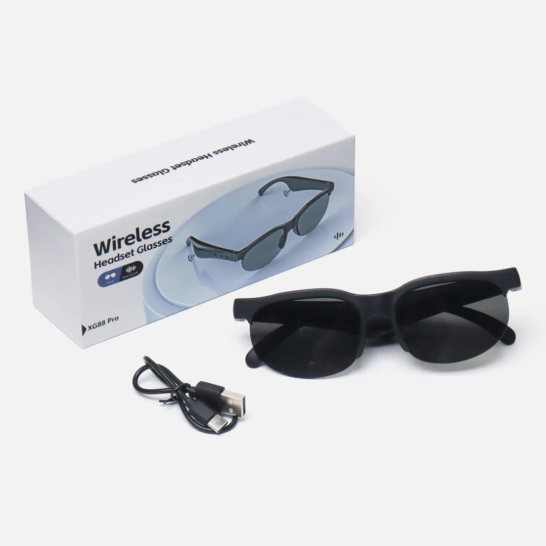 Black headset glasses with dark lenses, USB charging cable, and retail box.