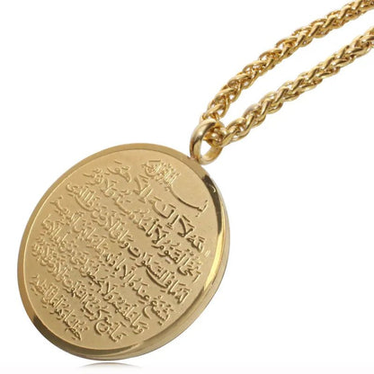 Close-up of the round gold Ayat al-Kursi pendant with engraved script and braided chain