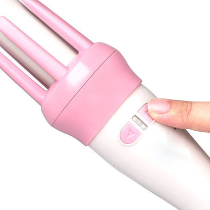 Close-up of pink rotation controls on a white hair curler handle