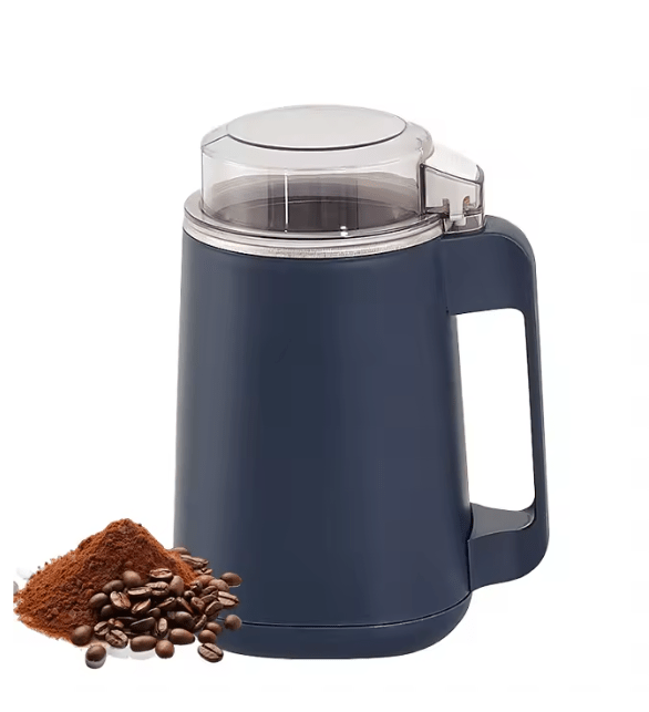 Navy electric coffee grinder with clear lid and handle, beside coffee beans and grounds