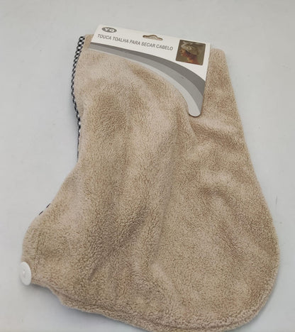 Beige hair drying cap towel with a hanging loop and white fastening button.
