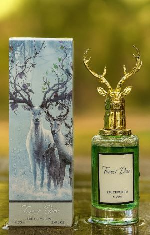 Forest Deer perfume in a green glass bottle with gold antler cap beside its deer-illustrated box.