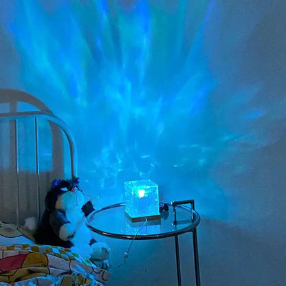 Dynamic lighting USB charging lamp glowing blue through its textured cube shade