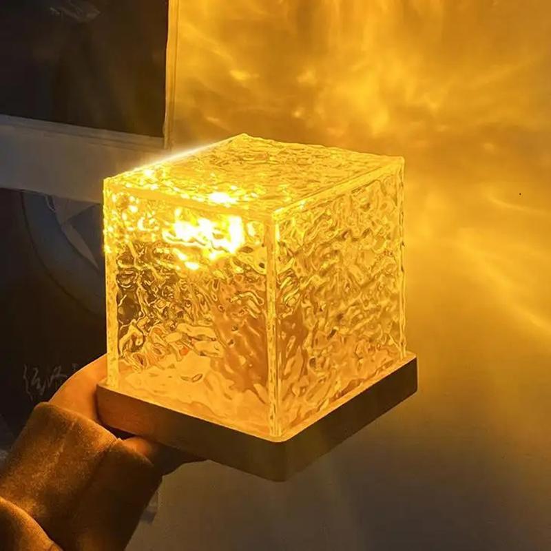 Dynamic lighting USB charging lamp with textured cube shade glowing warm amber
