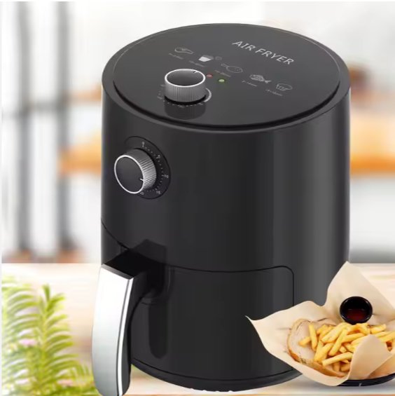 Black digital air fryer with silver handle, two control dials, and fries served beside it.