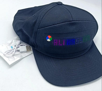 Navy Bluetooth cap with a front LED display and charging accessories