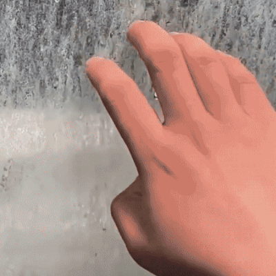 Bathroom cleaner shown being applied by hand to a stained tile surface