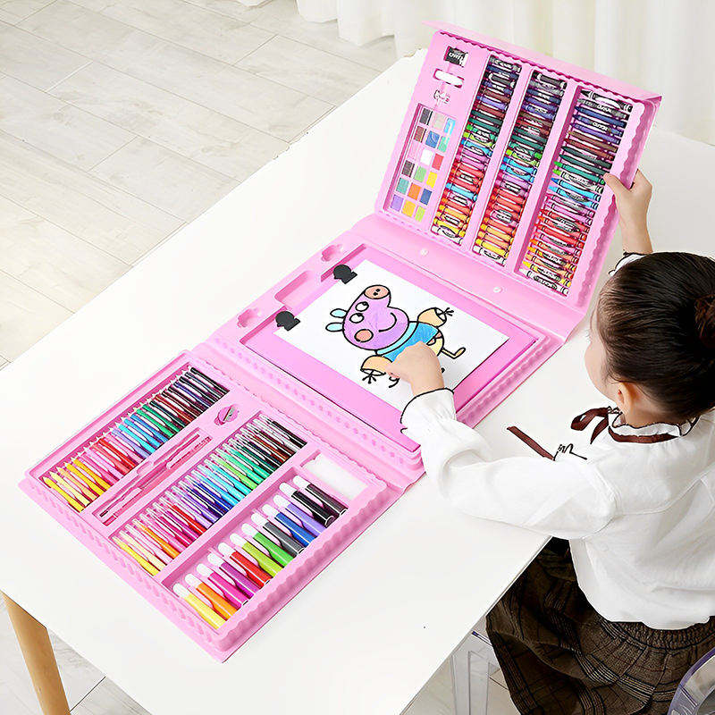 Open pink art set with rows of colorful supplies and a child drawing at the easel