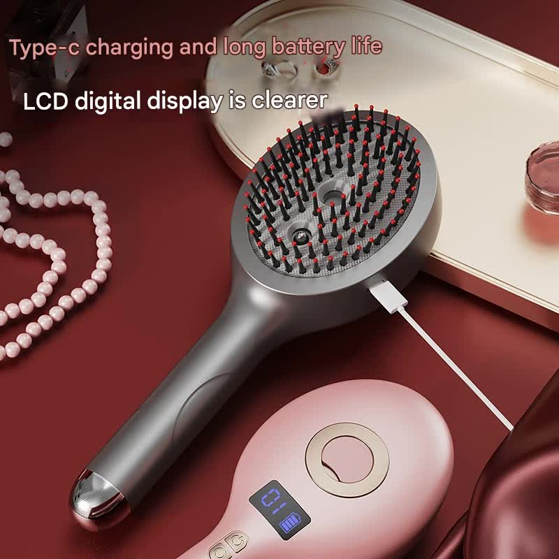 Silver massage spray comb with USB-C charging cable beside a pink model