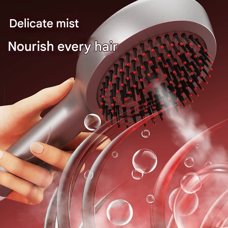Silver massage spray comb releasing a fine mist from its bristles