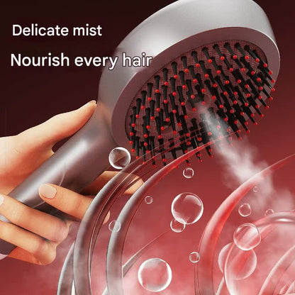 Silver massage spray comb releasing a fine mist from its bristles