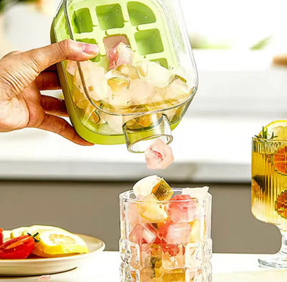 Ice cube tray bottle dispensing fruit-filled ice cubes into a glass
