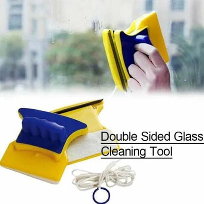 Double-sided magnetic glass cleaner held against a window, with safety cord