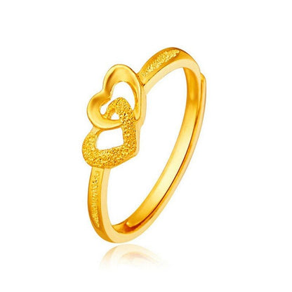 Gold-plated heart ring with a textured open-heart accent and slim band